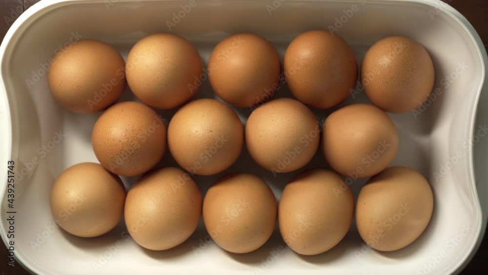 Placing chicken eggs in a plastic box Placing chicken eggs in a plastic box