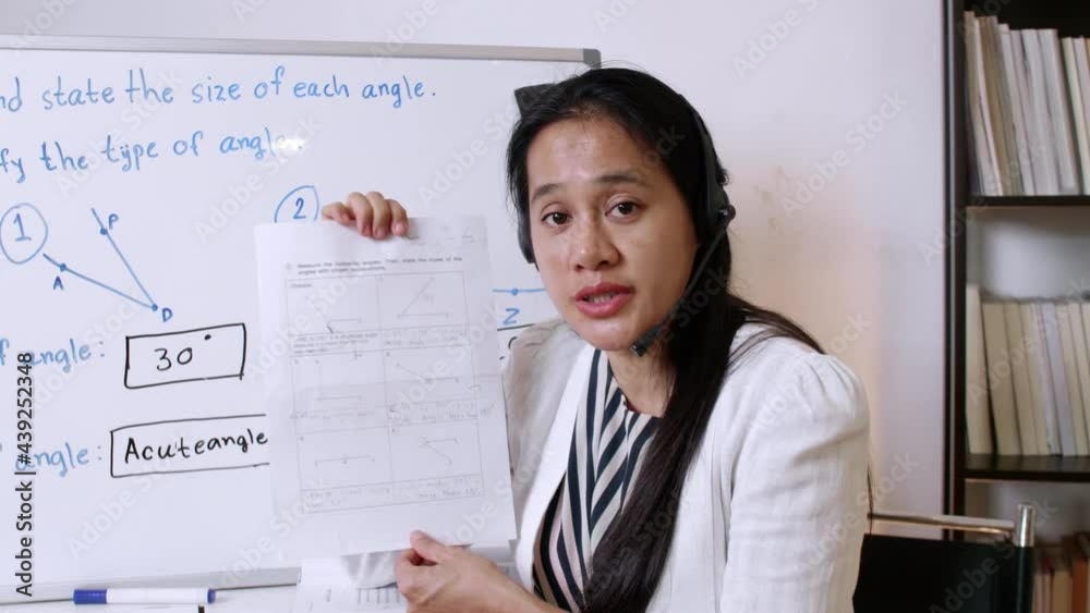 4K Asian woman teacher or tutor teaching online at home. Covid-19 new normal lifestyle during coronavirus lockdown quarantine. Online remote study 4K Asian woman teacher or tutor teaching online at home. Covid-19 new normal lifestyle during coronavirus lockdown quarantine. Online remote study