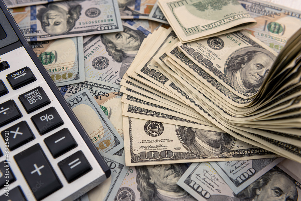 US dollars bills and calculator US dollars bills and calculator