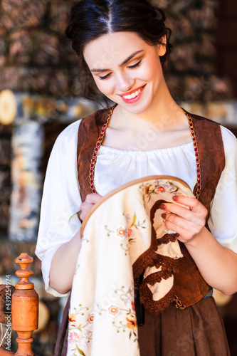 Lovely Caucasian Brunette Woman Posing With Fancywork Hoop in Retro Dress In Rural Environment. photo