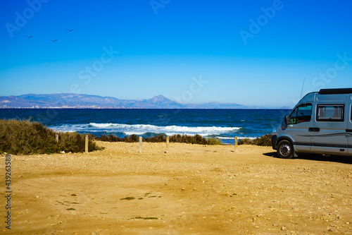 Camper van on beach, camping on nature © Voyagerix