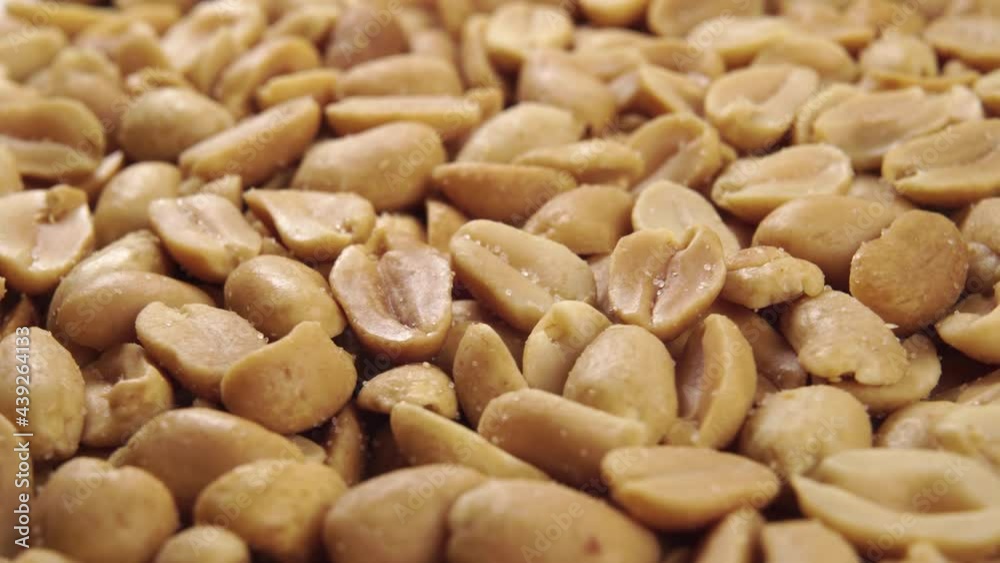 Salted roasted peanuts. Macro shot. Rotation. Tasty groundnut