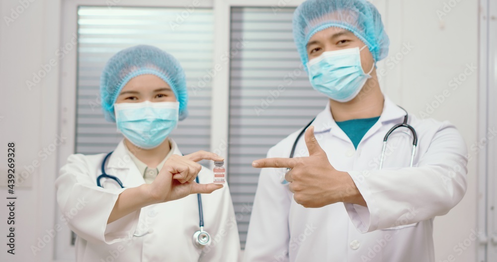 Healthcare worker holding and looking a bottle of covid-19 vaccine. Vaccination is one of the most effective ways to prevent diseases and helps the body’s immune system from virus. Healthcare worker holding and looking a bottle of covid-19 vaccine. Vaccination is one of the most effective ways to prevent diseases and helps the body’s immune system from virus.