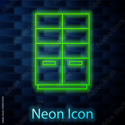 Glowing neon line Wardrobe icon isolated on brick wall background. Vector