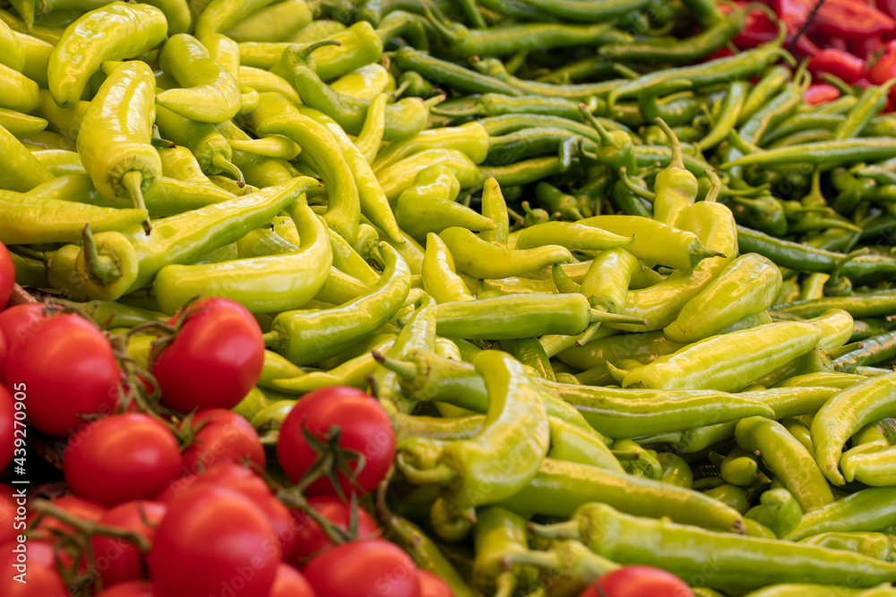 Varieties of vegetables sold at the grocery store. Tomatoes, peppers. Food background Varieties of vegetables sold at the grocery store. Tomatoes, peppers. Food background