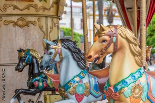 Detailed view of colorful horses from a vintage classic carousel © Miguel Almeida