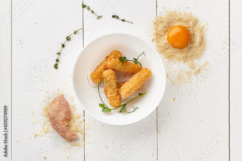 Foto Deep-fried chicken sticks battered in egg and bread crumbs