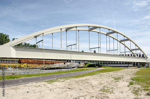 Rotterdam, The Netherlands, June 12, 2021: steel arch bridge in the harbour cargo railway line in Europoort industrial area