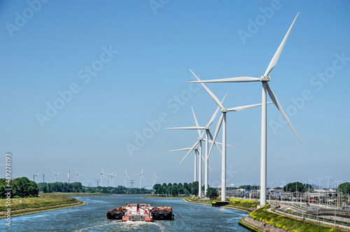 Fotografija Rotterdam, The Netherlands, June 12, 2021: cargo vessel on Hartel canal, lined w