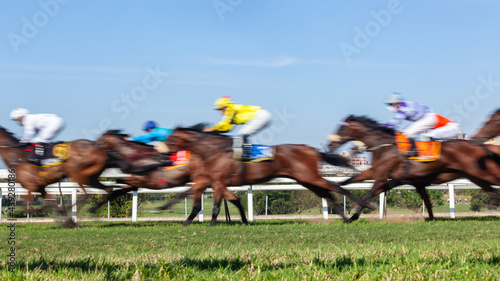 Horses Racing  Jockeys Unrecognizable Riding  Panoramic Motion Speed Blur Closeup Photo Action Image.
