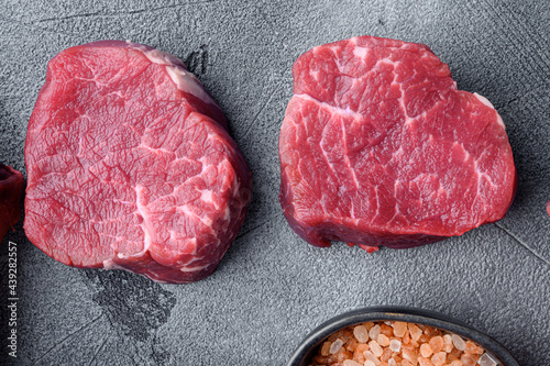 Prime Raw Fillet Mignon tenderloin steaks, on gray stone background, top view flat lay