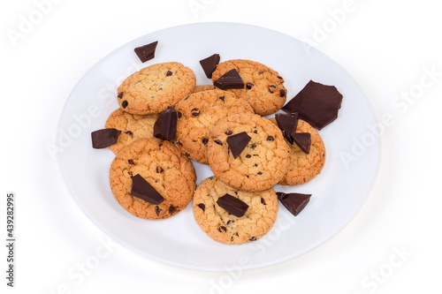 Chocolate chip cookies and broken chocolate pieces on white dish