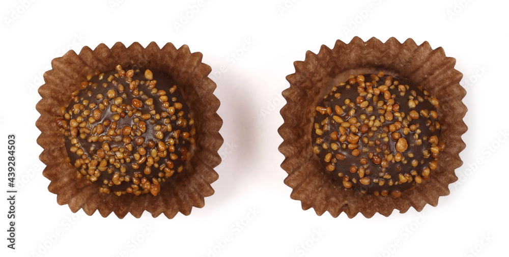 Chocolate truffles with caramel filling and peanut flavor in paper wrapper isolated on white background, top view Chocolate truffles with caramel filling and peanut flavor in paper wrapper isolated on white background, top view
