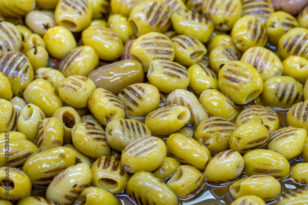 Grilled green olives. Close up. Green olives as background texture Grilled green olives. Close up. Green olives as background texture