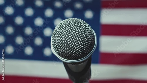 A Microphone In Front Of A Slow Motion USA Flag Ready For A Public Address From The President