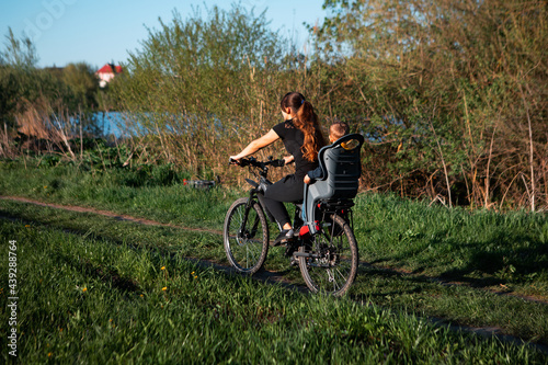 girl and child ride a bike in the park