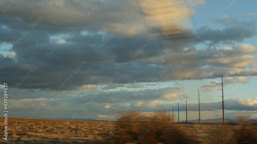 Road trip, driving auto from Death Valley to Las Vegas, Nevada USA. Hitchhiking traveling in America. Highway journey, dramatic atmosphere, sunset mountain and Mojave desert wilderness. View from car. Road trip, driving auto from Death Valley to Las Vegas, Nevada USA. Hitchhiking traveling in America. Highway journey, dramatic atmosphere, sunset mountain and Mojave desert wilderness. View from car.