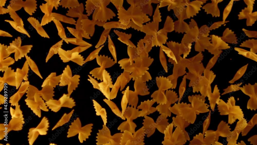 Super slow motion pasta farfalle dry. On a black background.Filmed on a high-speed camera at 1000 fps. High quality FullHD footage