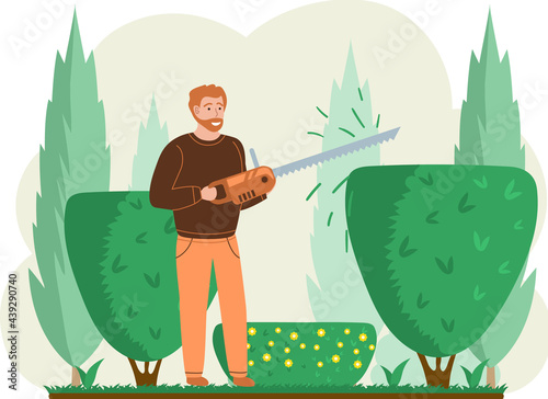 Man trimming plant with hand saw trimmer. Professional garden worker working with bush or tree in backyard. Gardening, planting topiary plants and hedges design. Agriculture, gardening and farming