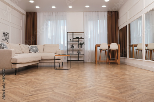 Modern living room with parquet flooring and stylish furniture photo