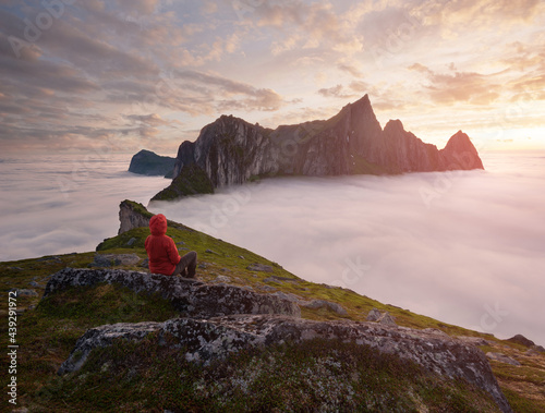 A tourist enjoying a view at the Mountain Hesten, Senja, Norway. Trekking in Norway, active life concept photo