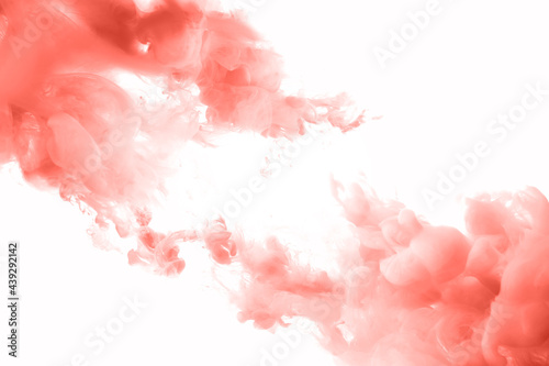 Coral ink splashes abstract background. Studio shot with seamless watercolor swirls in the water
