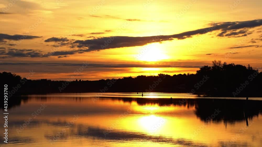 River reflections of clouds in a golden sky drifting past partial solar eclipse. River reflections of clouds in a golden sky drifting past partial solar eclipse.