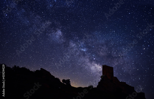 the milky way and the stars next to a castle photo