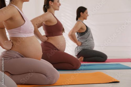 Group of pregnant women doing exercises in gym. Preparation for child birth