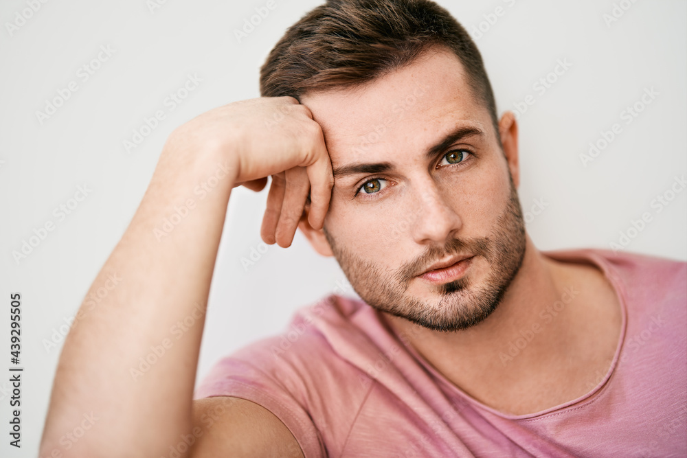 Closeup portrait of handsome sexy man looking at camera on white background Closeup portrait of handsome sexy man looking at camera on white background