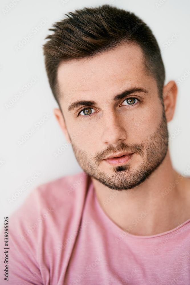 Closeup portrait of handsome sexy man looking at camera on white background Closeup portrait of handsome sexy man looking at camera on white background