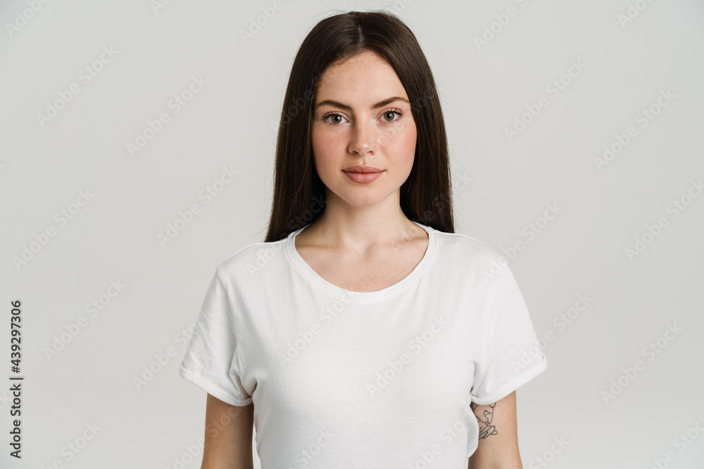 Fototapeta premium Young brunette woman posing and looking at camera