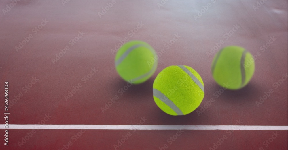 Composition of three tennis balls with copy space on tennis court
