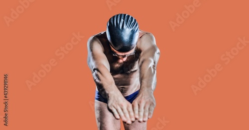 Fototapeta Naklejka Na Ścianę i Meble -  Composition of male swimmer with copy space isolated on orange background