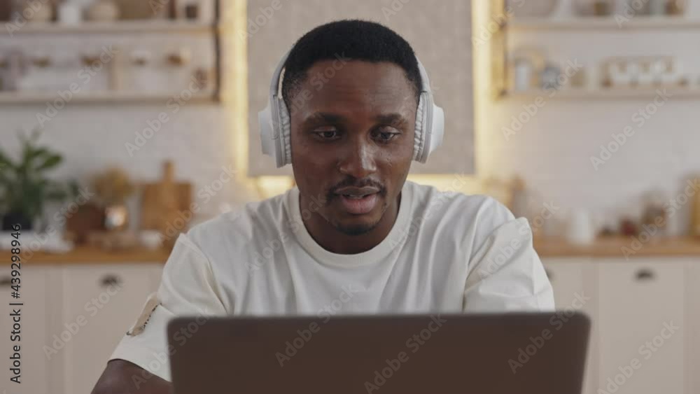 African student using headphones and laptop for video lesson African student using headphones and laptop for video lesson