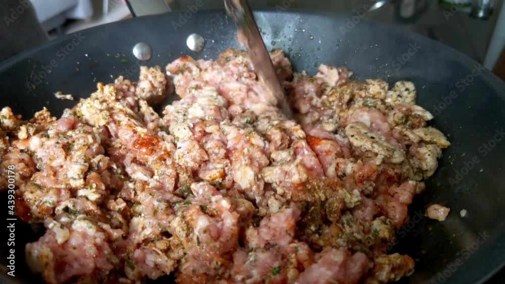 A close-up of minced meat cooking in a frying pan A close-up of minced meat cooking in a frying pan