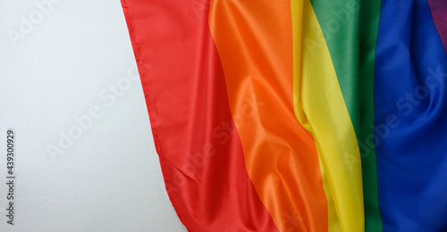 Fototapeta Naklejka Na Ścianę i Meble -  textile rainbow flag with waves, symbol of freedom of choice of lesbians, gays, bisexuals and transgender people, LGBT culture