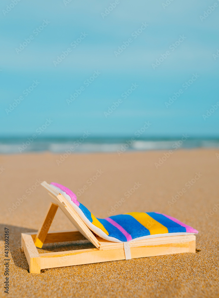 Fototapeta premium miniature deck chair on the beach