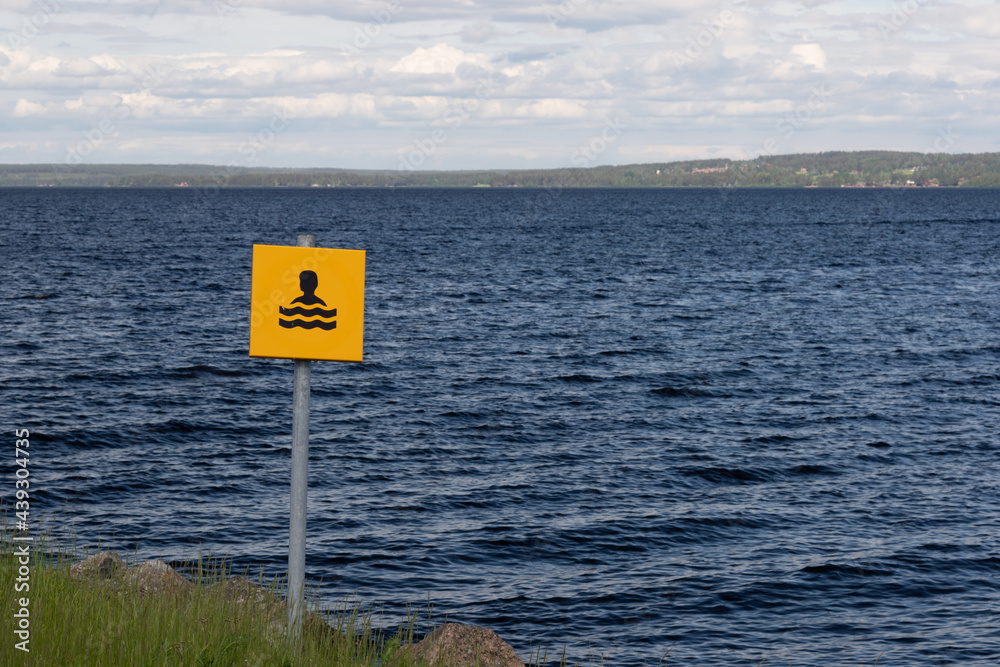 swim sign on a lakeshore water symbol