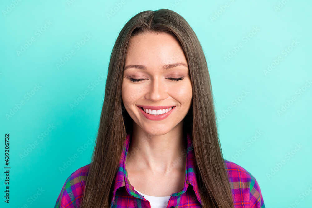 Photo of lovely long hairdo young lady wear checkered shirt isolated on vivid teal color background