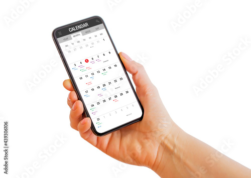 Person holding phone with calendar app on the screen