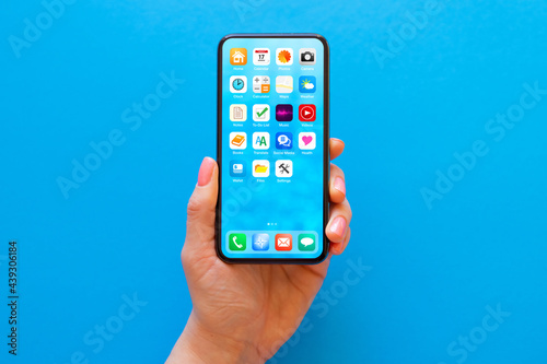 Mockup of mobile phone with sample icons on the screen on blue background