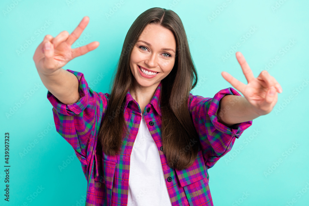 Portrait of attractive cheerful girl showing double v-sign good mood isolated over bright teal green color background Portrait of attractive cheerful girl showing double v-sign good mood isolated over bright teal green color background