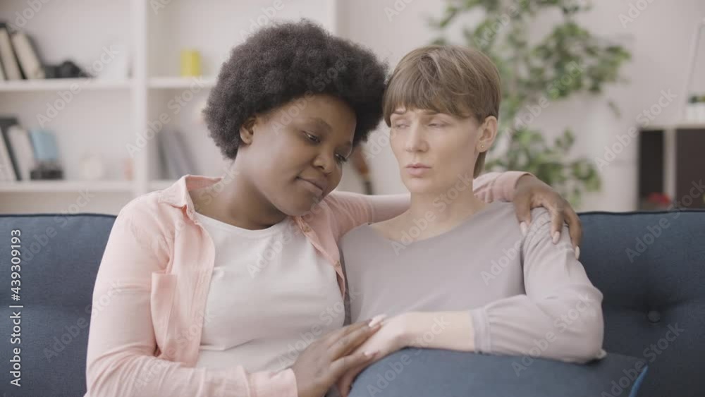 Black woman hugging and cheering up sad female friend, life problems, support Black woman hugging and cheering up sad female friend, life problems, support