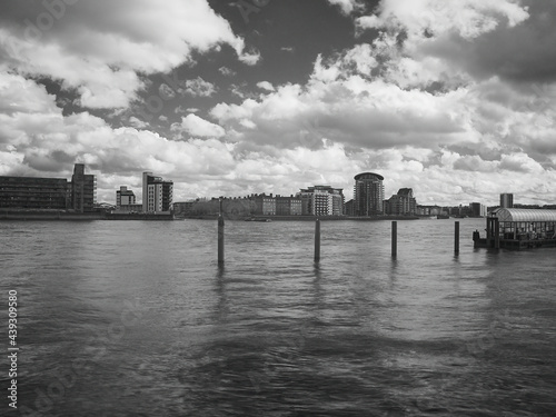 A slow shutter  infra-red filtered  monochrome view across the Thames from Canada Water to new residential buildings on the other side of the river.