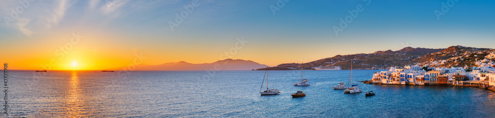 Sunset in Mykonos, Greece, with cruise ship and yachts in the harbor