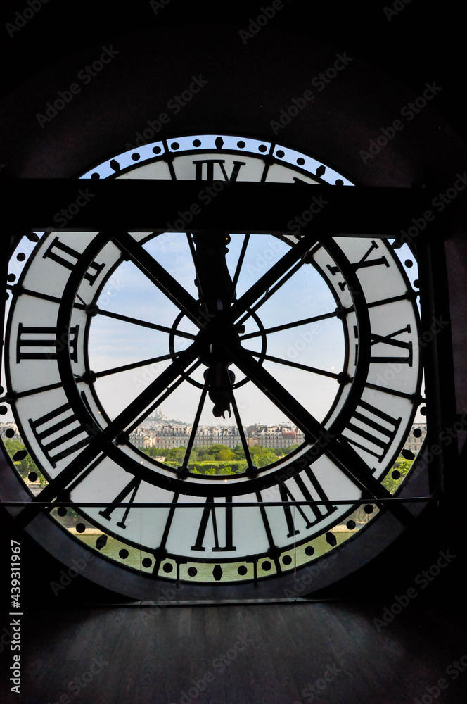 Naklejka premium View on the city through the clock mechanism