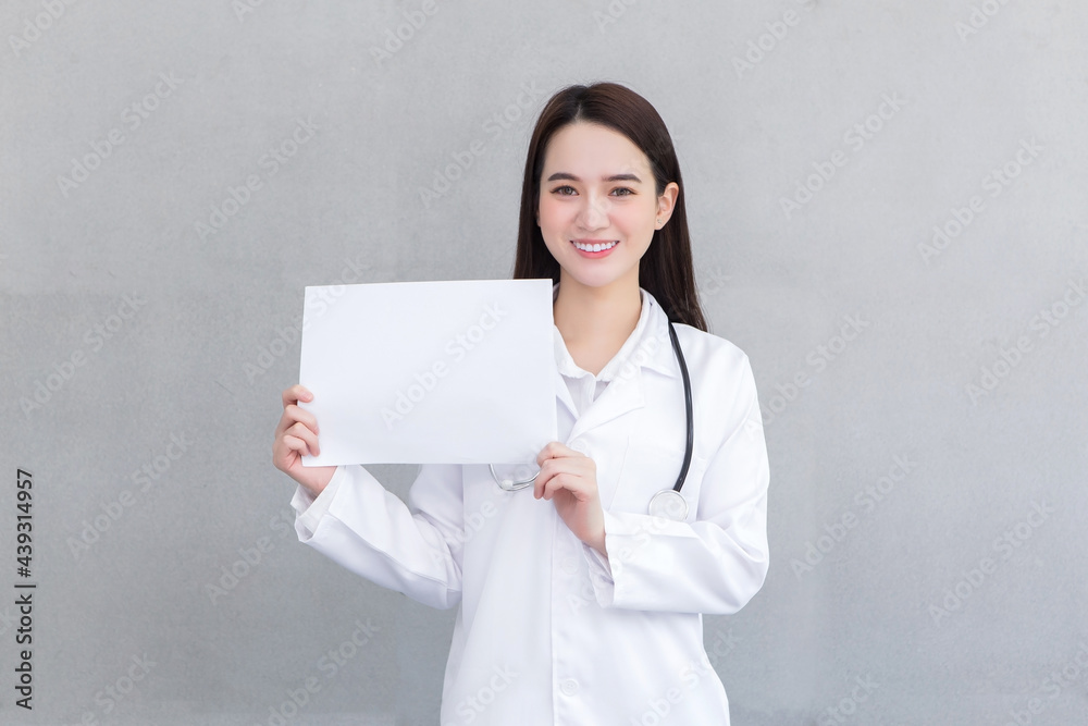 Asian professional doctor woman who wears medical coat holds and shows white paper to present something in healthcare concept. Asian professional doctor woman who wears medical coat holds and shows white paper to present something in healthcare concept.