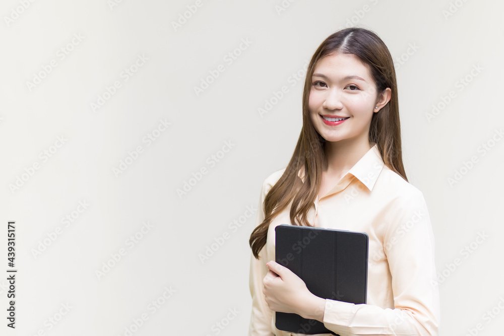 Asian beautiful woman with long hair who wear a long-sleeved shirt stands holding tablet smilie and happy on white background. Asian beautiful woman with long hair who wear a long-sleeved shirt stands holding tablet smilie and happy on white background.