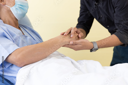 Closeup shot of holding hand elderly man in a hospital ward. Holding Hands, Encouragement, Care, health insurance, Life Insurance and financial planning